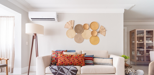 Integração, aconchego e pontos de cor definem projeto de apartamento de universitários Projeto: Isabella Nalon, produção Coletivo Borogodó| A sala de estar combina tons neutros com toques vibrantes em acessórios estratégicos. Elementos como adornos de parede em fibras naturais e a luminária de piso contribuem para um ambiente aconchegante