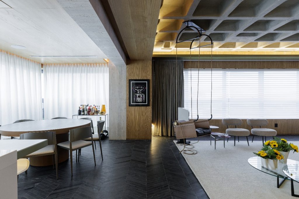 Projeto: Rodolfo Fontana | O piso em ardósia negra, em espinha de peixe, reforça a atmosfera urbana e sofisticada da área social.