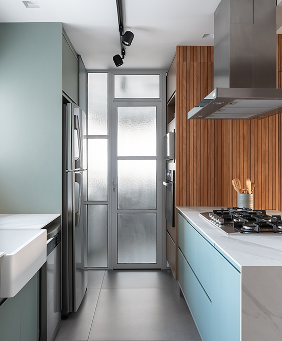 Projeto: Bruna Blanco | A ilha com cooktop foi posicionada dessa forma, após pedido do cliente e estudo do layout, tudo para que quem cozinha possa apreciar o pôr do sol, enquanto cozinha e interage com as visitas.