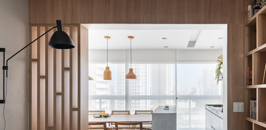 Apartamento assinado por Bruna Blanco é refúgio que celebra o pôr do sol, convivência e estilo contemporâneo Projeto: Bruna Blanco | A integração dos espaços favoreceu a unidade e a entrada. de iluminação natural na área social.